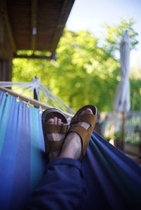 Low section of man relaxing on hammock