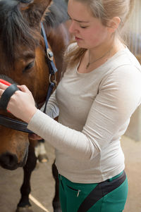 Close-up of young woman with horse