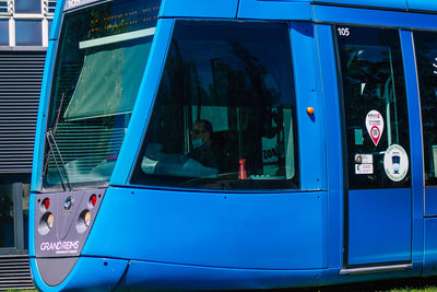 Low angle view of bus sitting on glass window