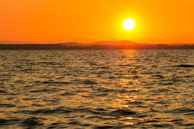 Scenic view of sea against romantic sky at sunset