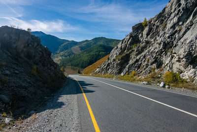 Road amidst mountains against sky