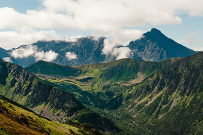 Scenic view of mountains against cloudy sky
