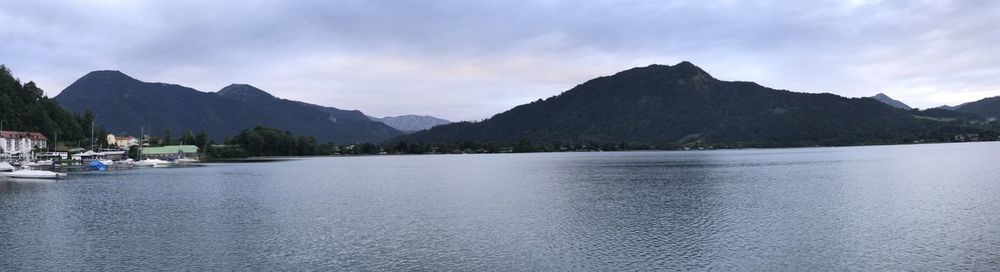 Scenic view of lake by mountains against sky