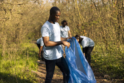 Side view of young woman standing on field