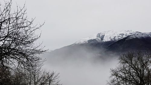 Low angle view of snowcapped mountain against sky