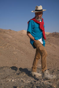 Vertical view of senior man standing in the desert 