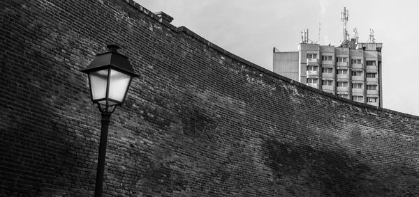 Low angle view of street light against building