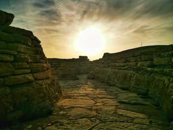 View of stone wall at sunset