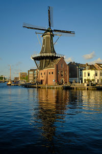 Haarlem, netherlands. the famous adriaan windmill on the river de spaarne on a clear day.