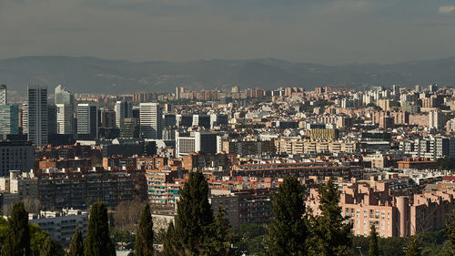 High angle view of city buildings against sky