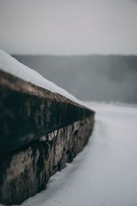 Close-up of retaining wall by sea against sky