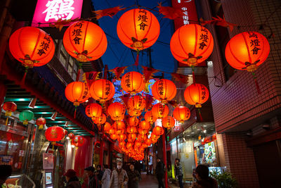 Illuminated lanterns hanging in city at night