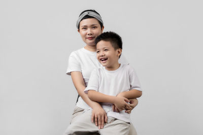 Full length of happy boy against white background