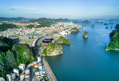 High angle view of river amidst cityscape against sky