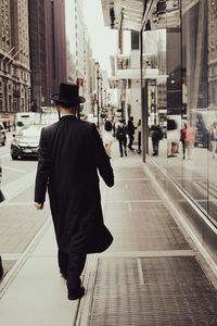 Rear view of man walking in city