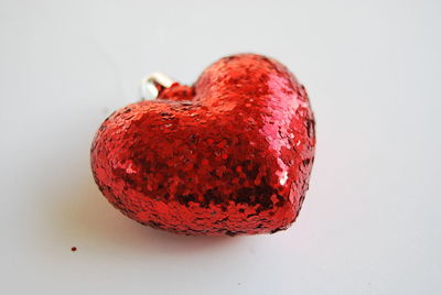 Close-up of red fruit over white background