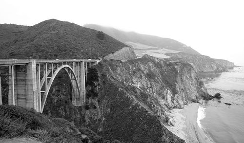 Panoramic view of bridge over mountains against clear sky