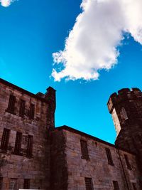 Low angle view of historical building against blue sky