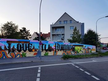 Road by building against sky
