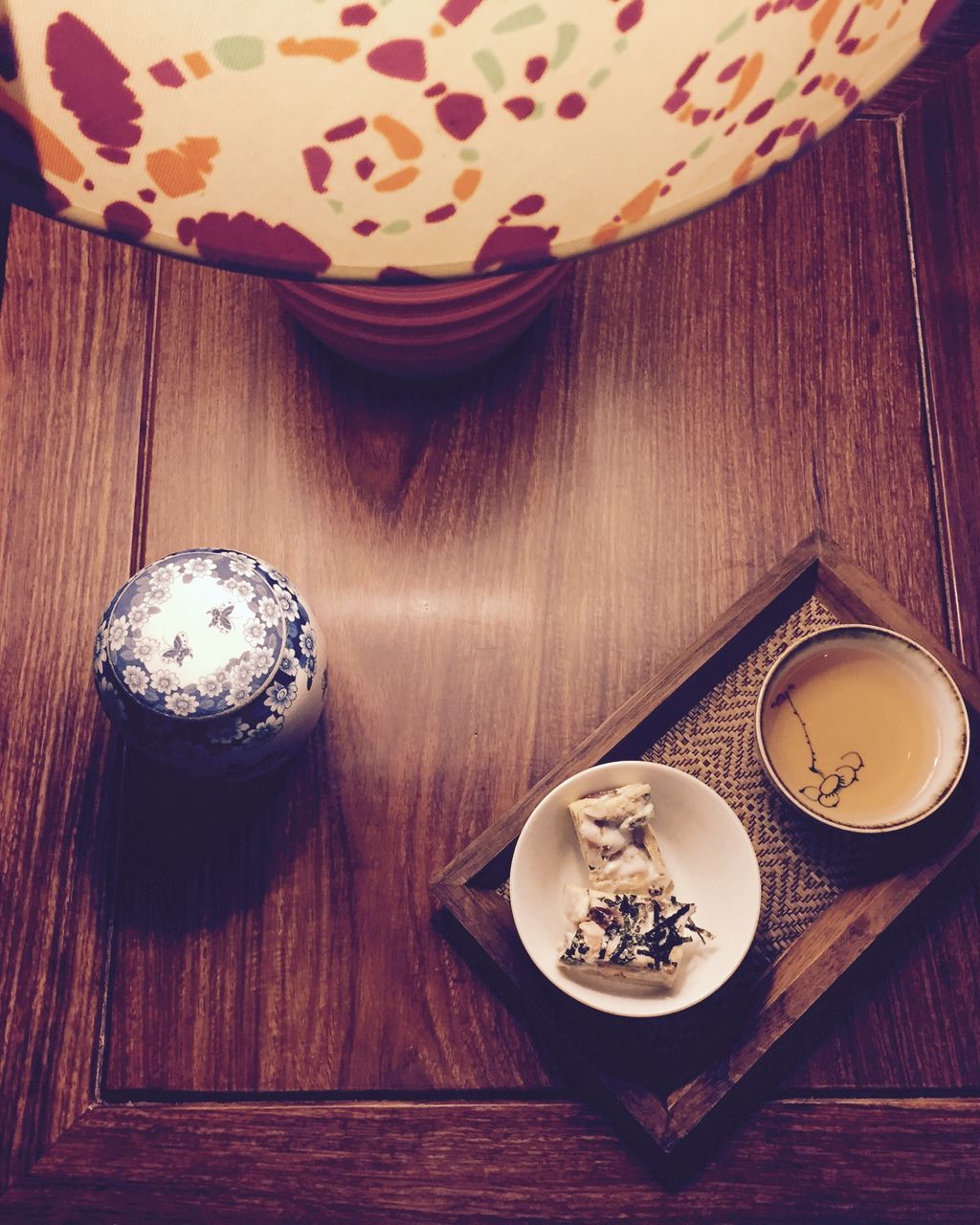 indoors, table, still life, wood - material, high angle view, home interior, food and drink, decoration, wooden, close-up, no people, design, directly above, old-fashioned, floral pattern, plate, art and craft, pattern, antique, wood