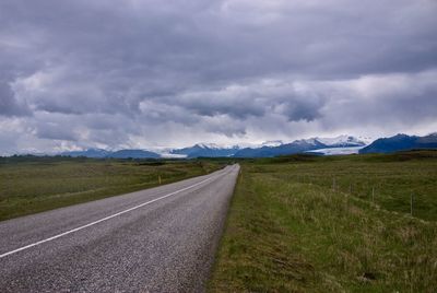 Empty road along countryside landscape