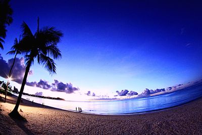 Scenic view of beach against blue sky