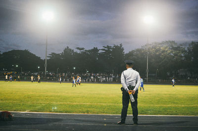 People walking on grassy field