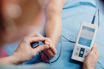 Midsection of man using mobile phone