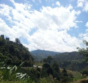 Scenic view of mountains against cloudy sky