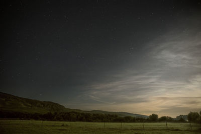 Scenic view of field against sky at night