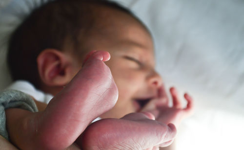 Close-up of baby sleeping on bed