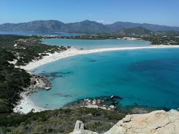 Scenic view of sea and mountains against sky