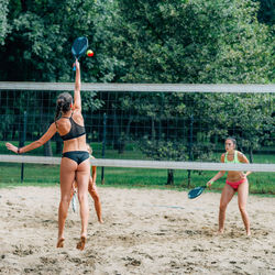 Beach tennis players at the net