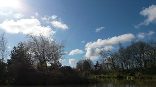 Scenic view of river against cloudy sky