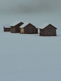 Barn in winter against sky