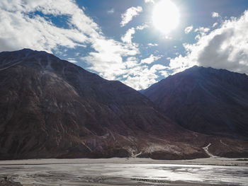 Scenic view of mountains against cloudy sky