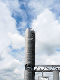 Low angle view of smoke stack against sky