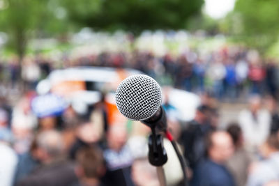 Close-up of microphone against crowd