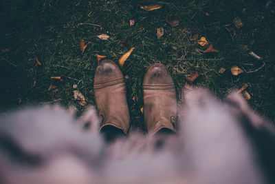 Low section of person standing on tiled floor