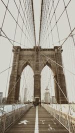 People at cable-stayed brooklyn bridge against sky