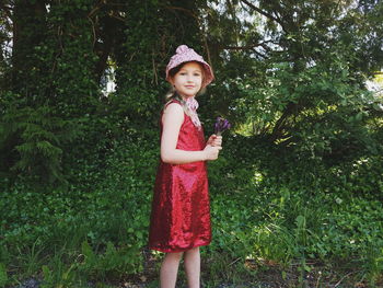 Portrait of girl standing against tree