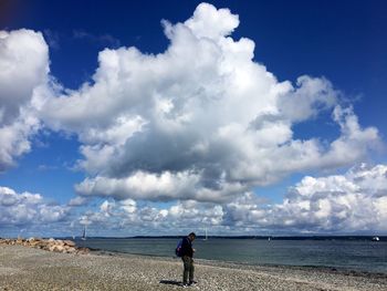 Woman on beach against sky