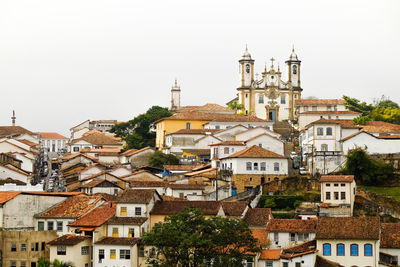 Church with townscape against sky