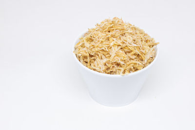 High angle view of bread in bowl against white background
