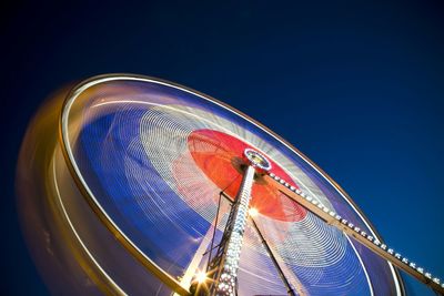 Low angle view of illuminated ferris wheel