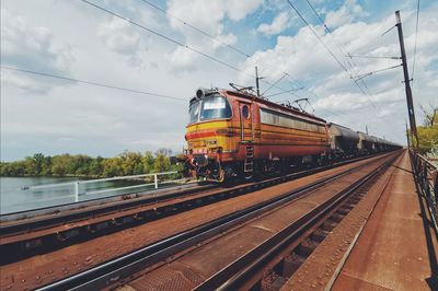 Train on railroad tracks against sky