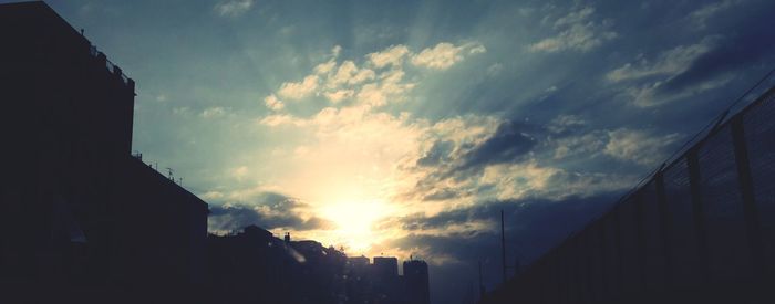 Low angle view of buildings against sky during sunset