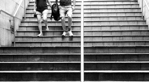 Low section of people walking on staircase