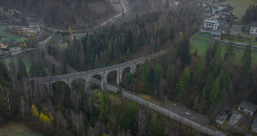 High angle view of bridge amidst trees and mountains
