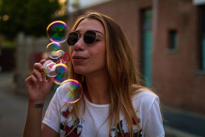 Close-up of young woman in bubbles